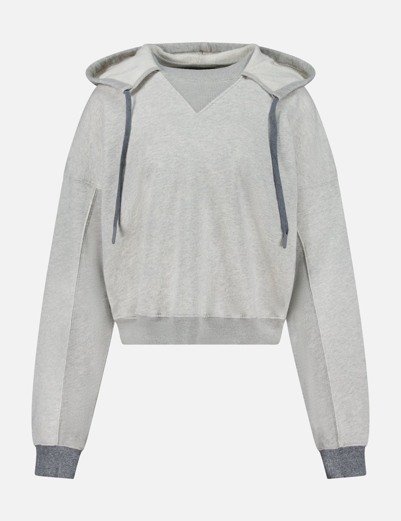 The Half Base Hoodie Sweatshirt by MOTHER features a light gray color, V-neck design, and is accented with dark gray drawstrings along with matching ribbed cuffs and hem. Crafted from soft fleece-lined cotton, this oversized hoodie offers a relaxed fit with long sleeves and is showcased against a plain white background.