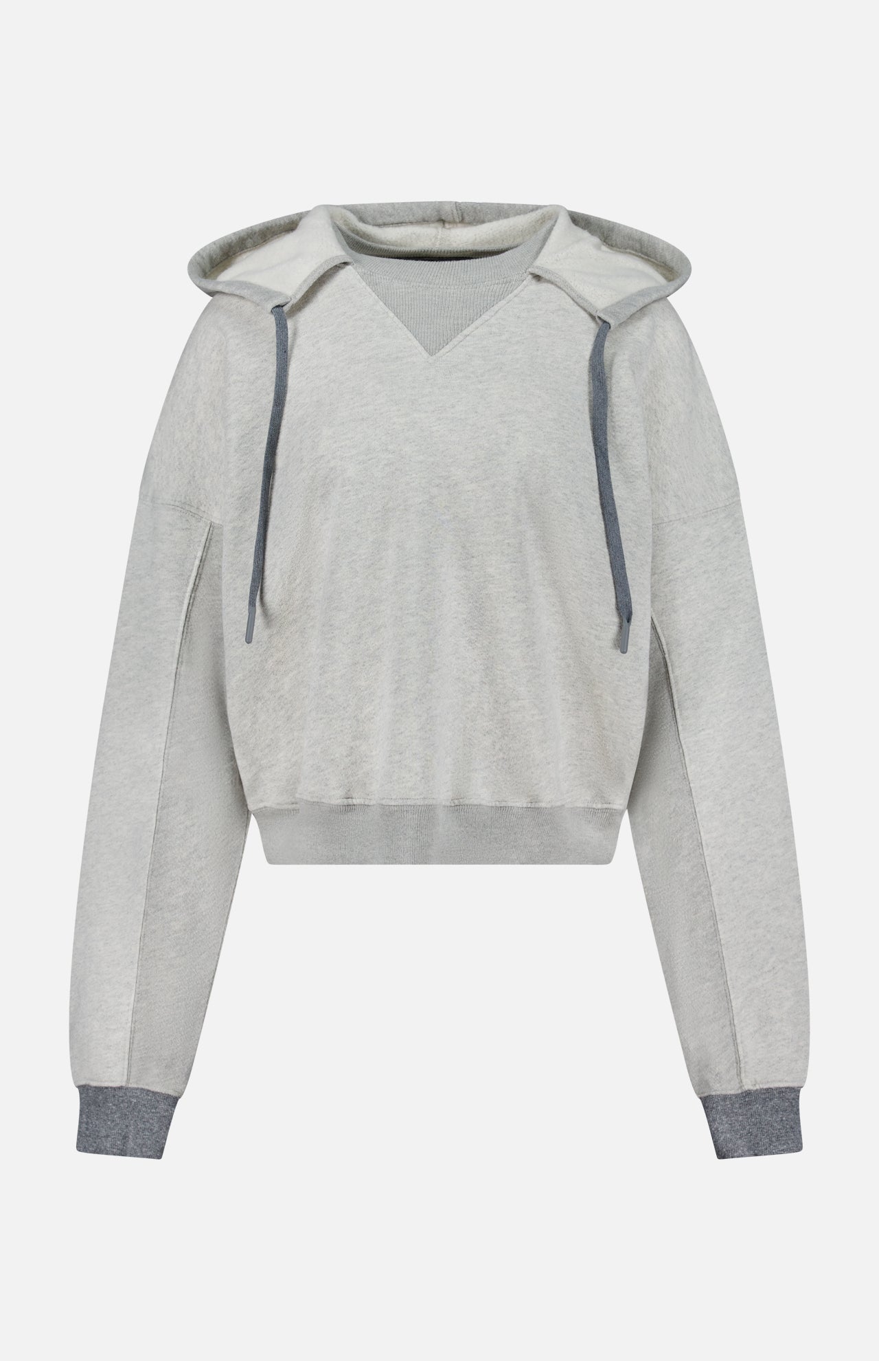 The Half Base Hoodie Sweatshirt by MOTHER features a light gray color, V-neck design, and is accented with dark gray drawstrings along with matching ribbed cuffs and hem. Crafted from soft fleece-lined cotton, this oversized hoodie offers a relaxed fit with long sleeves and is showcased against a plain white background.