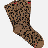 Introducing The Half-Step Cheetah Socks by MOTHER—a pair of brown crew socks featuring a striking black cheetah print and subtle red text accents near the top and toe. Displayed on a crisp white background, these statement socks are perfect for anyone looking to elevate their style.