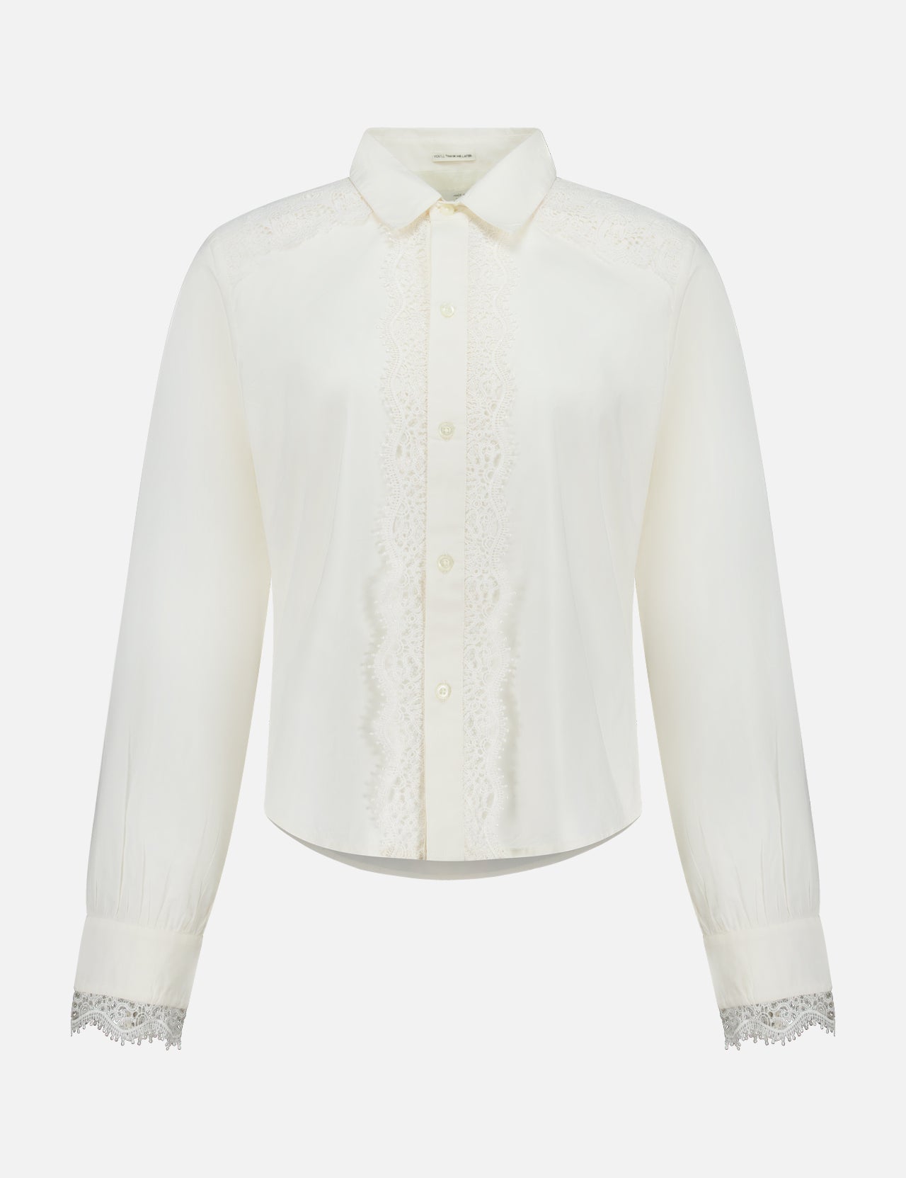 The Headup Honey Shirt by MOTHER is a white long-sleeve blouse with lace trim along the button placket and cuffs, featuring a classic collar and button-down front that combines timeless elegance with subtle western-inspired detailing, displayed on a plain white background.