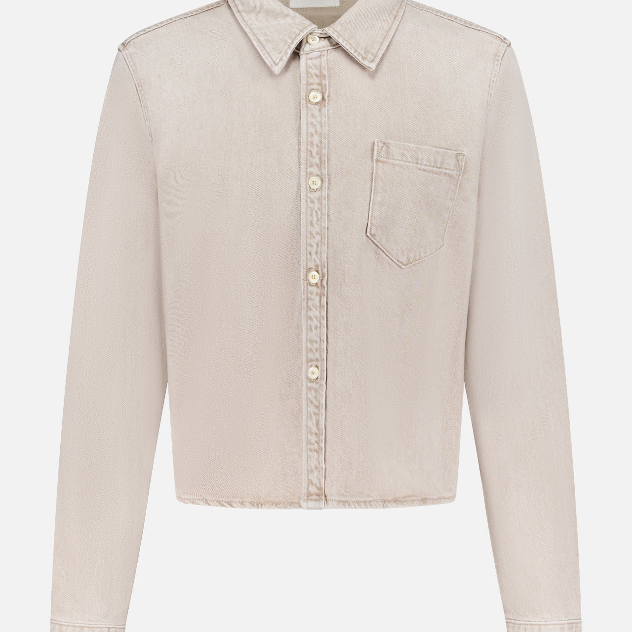 The Honor Roll Cropped Shirt by MOTHER is a light beige women's button-up with long sleeves, a pointed collar, single chest pocket, and cropped hem, shown on a plain white background.