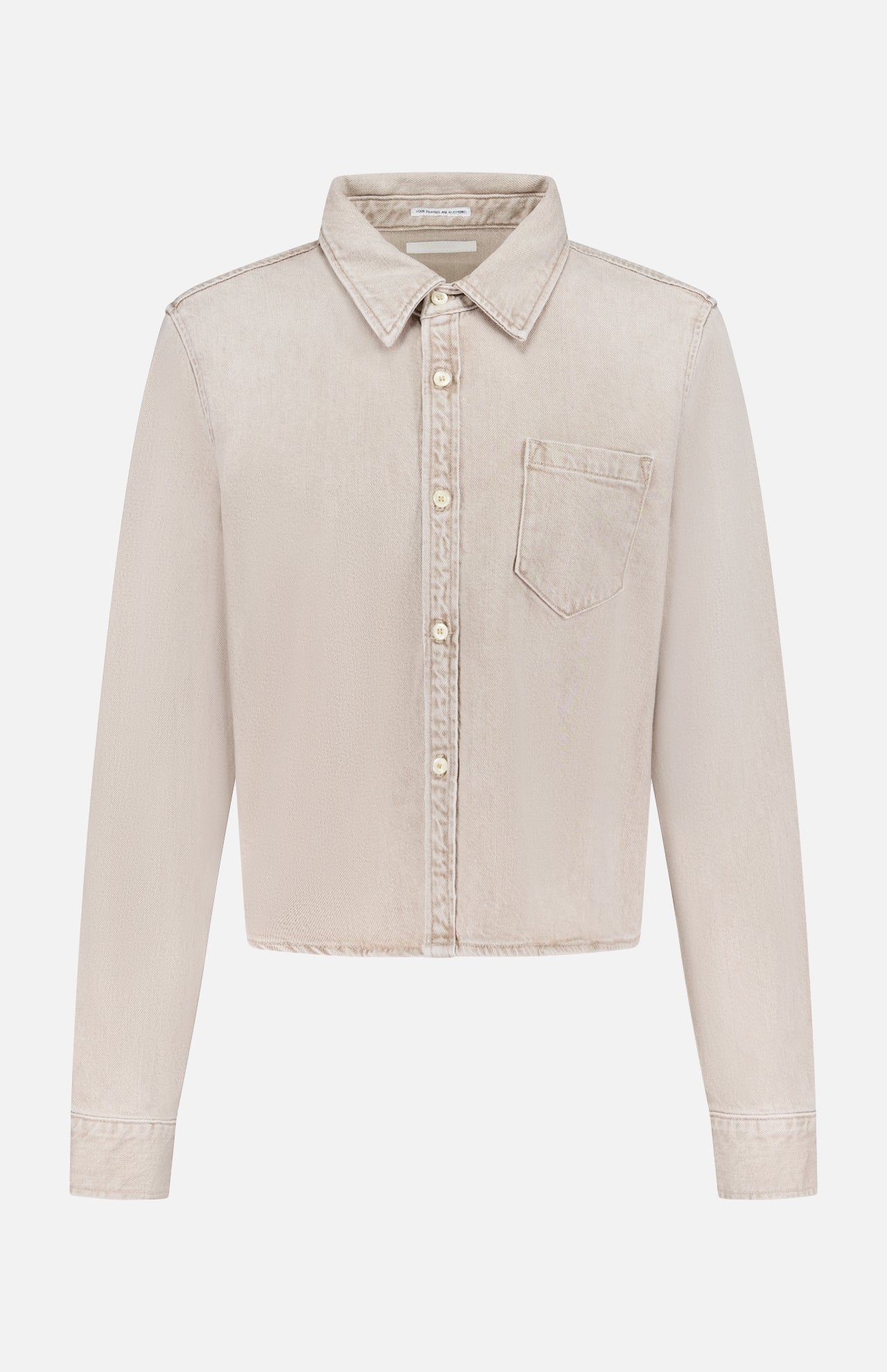 The Honor Roll Cropped Shirt by MOTHER is a light beige women's button-up with long sleeves, a pointed collar, single chest pocket, and cropped hem, shown on a plain white background.