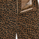 Close-up of The Hustler Flood Pant in Leap Year by MOTHER, a pair of high-rise flare pants in leopard-print stretch corduroy, shown with the zipper and button undone to reveal part of the inside lining and pockets.