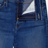 A close-up of The Insider Skimp Jean in Taking Chances by MOTHER shows blue stretch denim with a partially open zipper fly, high-waisted bootcut waistband, belt loops, and copper rivet buttons for a vintage-inspired look.