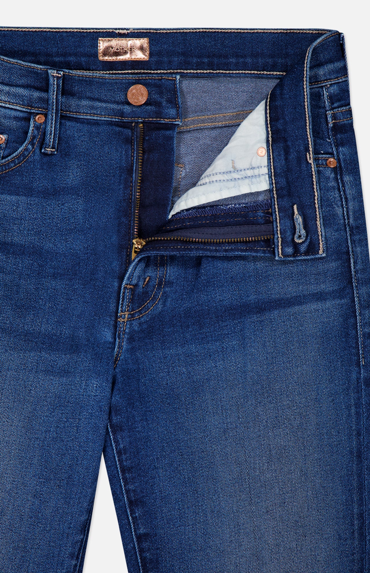 A close-up of The Insider Skimp Jean in Taking Chances by MOTHER shows blue stretch denim with a partially open zipper fly, high-waisted bootcut waistband, belt loops, and copper rivet buttons for a vintage-inspired look.