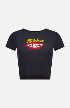 Introducing The Itty Bitty Ringer T-shirt by MOTHER—a stylish black shrunken crew neck tee with short sleeves and a cropped hem. This eco-friendly top is crafted from recycled cotton and features a bold graphic of red lips with white teeth, topped with the word "MOTHER" in yellow text above the lips.