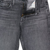 A pair of MOTHER The Jinx Sneak Jeans in Cliffhanger, featuring bootcut gray stretch denim with a partially unzipped front zipper and fastened button. The waistband and pocket details are visible.