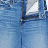 A close-up of MOTHER’s The Kick It Straight Leg Jean in Bitchin' mid-blue wash, showing a partially open zipper, white pocket lining, visible stitching, copper rivets, and a button closure at the high-rise waistband.