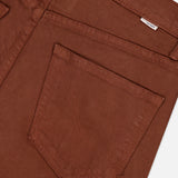 Close-up of the back pocket area of MOTHER’s The Kick It Pant in Bison, featuring visible stitching and a small white label near the waistband.