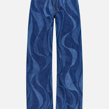 The Lasso Sneak Abstract Print Jean by MOTHER features a high-rise, wide-leg blue denim design with wavy abstract stripes in two shades, front pockets, belt loops, and a button-zipper closure.