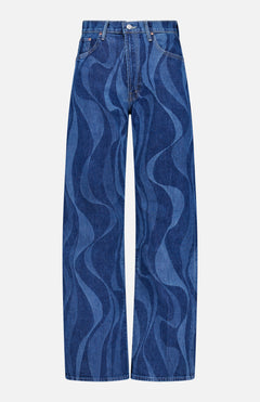 The Lasso Sneak Abstract Print Jean by MOTHER features a high-rise, wide-leg blue denim design with wavy abstract stripes in two shades, front pockets, belt loops, and a button-zipper closure.