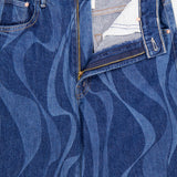 The Lasso Sneak Abstract Print Jean by MOTHER features a blue high-rise design with wavy, abstract stripes and a partially unzipped front showing the white inner pocket lining.