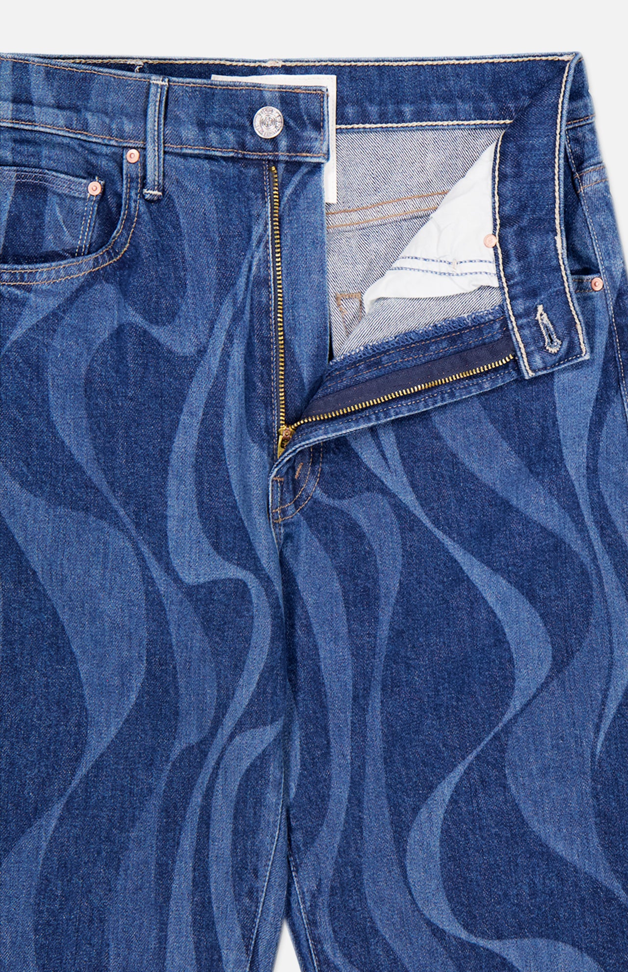 The Lasso Sneak Abstract Print Jean by MOTHER features a blue high-rise design with wavy, abstract stripes and a partially unzipped front showing the white inner pocket lining.