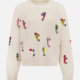 The Raglan Pullover Sweater by MOTHER is a cream-colored 100% cotton sweater with colorful abstract embroidered figures in various poses across the front, sleeves, and body.