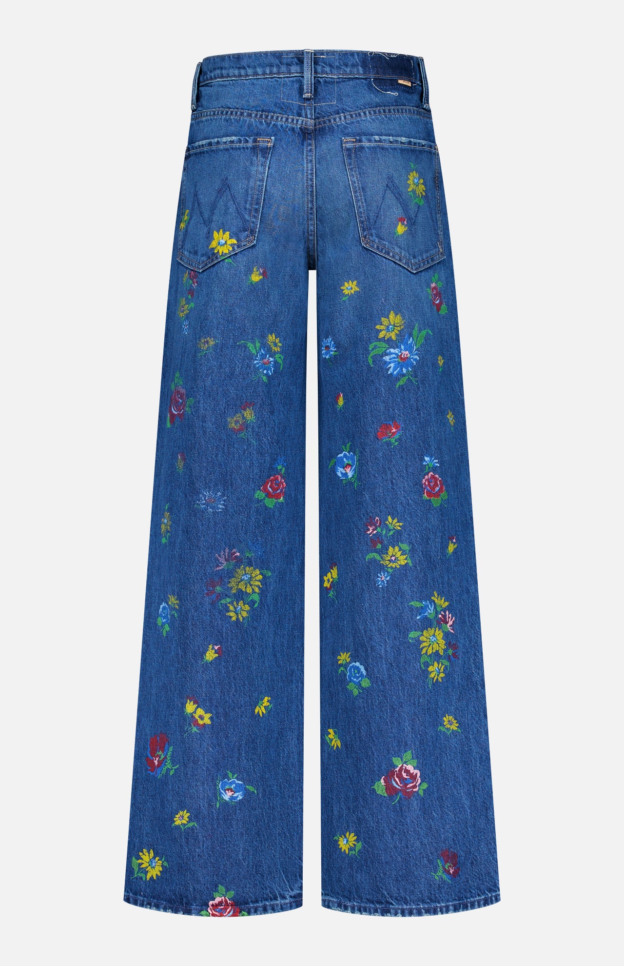 Back view of The Rerun Zip Sneak Floral Print Jeans by MOTHER, featuring blue high-waisted wide-leg denim with two back pockets and vibrant floral prints scattered across the fabric.