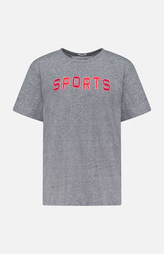 The Rowdy Sports T-Shirt by MOTHER is a grey, oversized crew neck made from heathered cotton-blend. It features bold red "SPORTS" lettering across the chest and is shown on a plain white background.