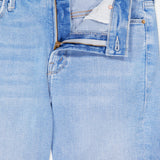 The Runaway Skinny Jean in Derby Doll by MOTHER features a light blue wash with the waistband and zipper partly open, revealing the white inner lining and contrast stitching. These mid-rise jeans include front pockets accented with copper rivets and a small coin pocket on the right.