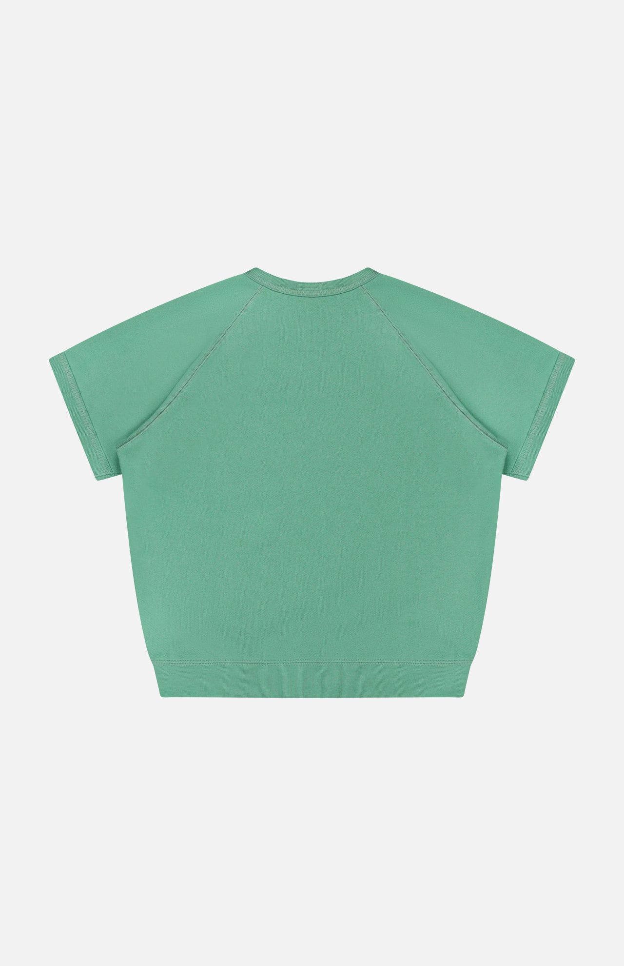 The Short Sleeve Concert Shirt by MOTHER is a green, loose-fit raglan sweatshirt with short sleeves and crew neck, shown from the back on a plain white background. Made from 100% cotton, it features no visible patterns or logos.