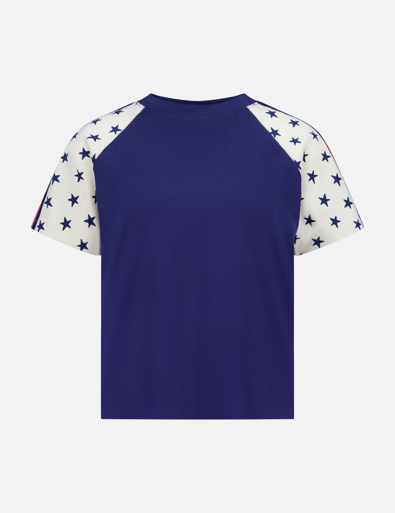 The Concert Race T-shirt by MOTHER is a 100% cotton raglan tee featuring a solid navy blue back and white sleeves with navy blue stars, inspired by classic Americana style. Shown against a plain white background.