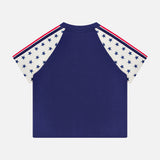 The Concert Race T-shirt by MOTHER features white sleeves with blue stars, red stripes on the shoulders, and a blue body. Made from 100% cotton, it's shown on a white background.