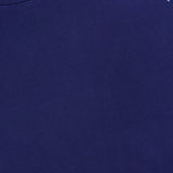 Close-up of The Concert Race T-shirt by MOTHER: a navy blue raglan tee with a white shoulder panel covered in dark blue stars. Made from 100% cotton for comfort and Americana style, with partial MOTHER label visible at the top left.