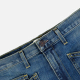 Close-up of the waistband and front pockets of the Nili Lotan Shon Jean in Classic Wash, featuring contrast stitching and a metal button.