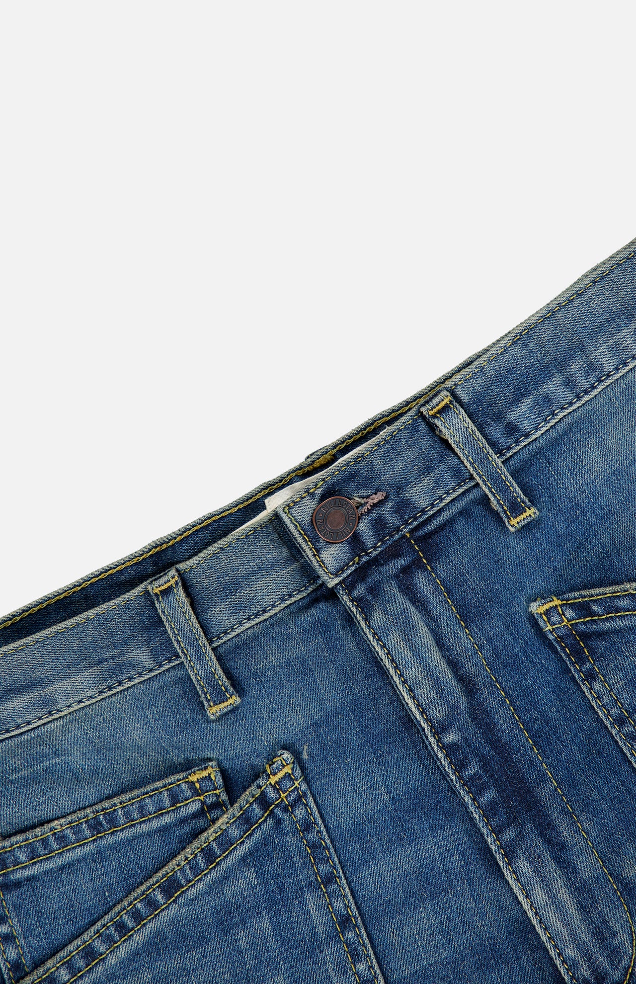 Close-up of the waistband and front pockets of the Nili Lotan Shon Jean in Classic Wash, featuring contrast stitching and a metal button.