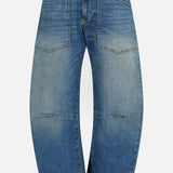 Nili Lotan Shon Jean in Classic Wash: mid-rise blue jeans with a curved, wide-leg bow leg silhouette and two large patch pockets on the front.