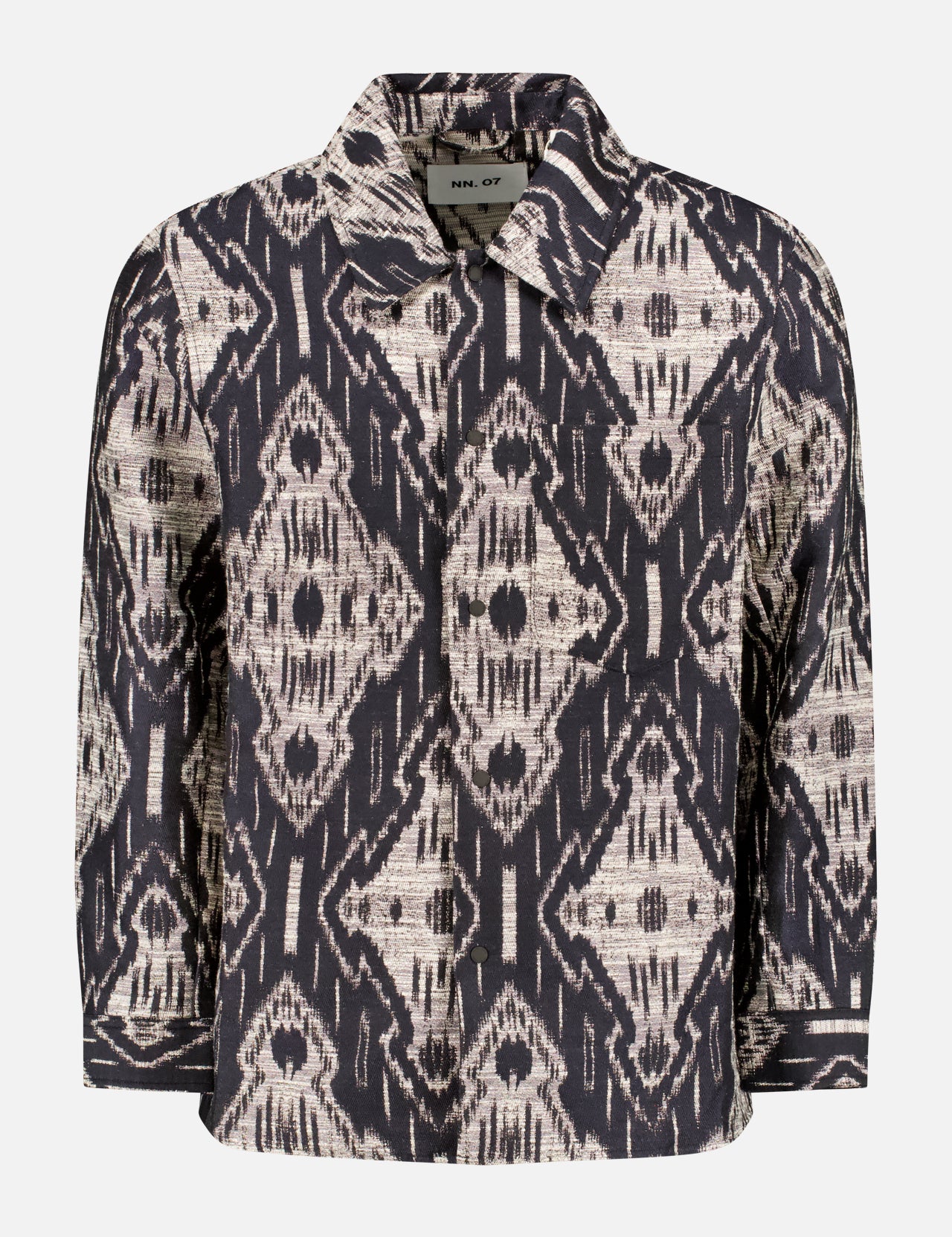 The NN07 Blaze Pattern Overshirt is a long-sleeved jacket with a bold black and beige geometric ikat jacquard, featuring a collar, button closure, and cuffs. Shown against a plain white background—ideal for modern-casual style.
