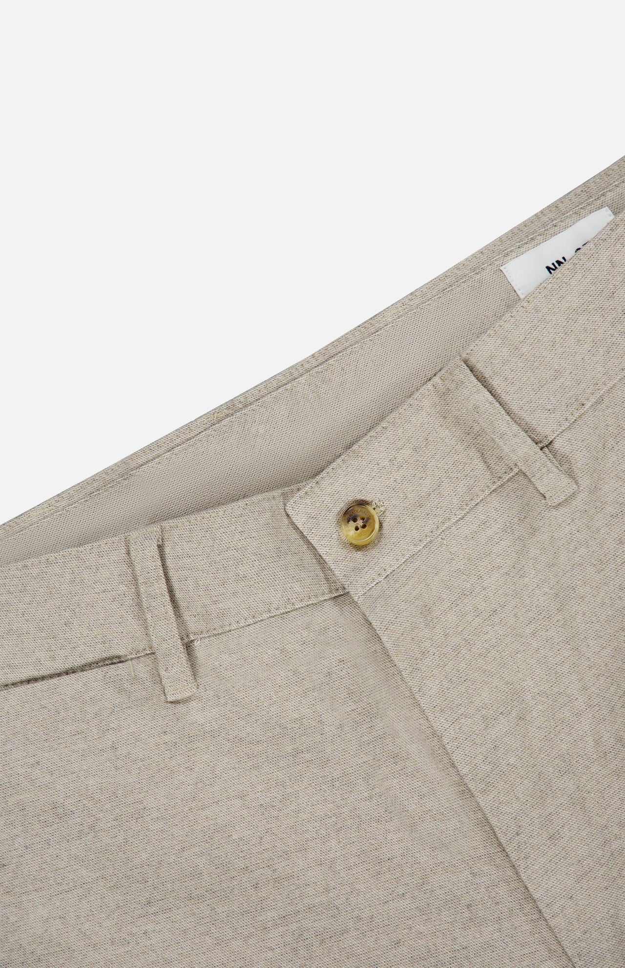 Close-up of the Aden Office Stretch Pant by NN07 in light grey, made from an organic cotton blend with a brown button, belt loops, and visible waistband label—perfect for a modern-casual look.