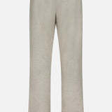 Aden Office Stretch Pant by NN07 shown from the back in beige, made from an organic cotton blend with belt loops, two back pockets, and a white label by the right waistband—perfect for a modern-casual look.