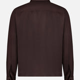 The NN07 Alban 2-way Zip Overshirt is displayed from the back, showcasing its dark brown color, long sleeves with buttoned cuffs, collared design, and straight hem—all set against a plain white background.