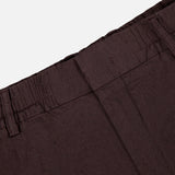 Close-up of the waistband and upper section of the NN07 Billie Drawstring Shorts in dark brown, highlighting belt loops and seam details against a plain background—crafted from a comfortable linen viscose blend.
