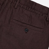 Close-up of NN07's Billie Drawstring Shorts in dark brown, featuring a waistband, belt loop, and a single back pocket with button closure. Made from textured cotton-linen viscose for comfort and style.