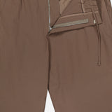 The NN07 Billie Seersucker Trouser Pant features a brown pinstriped seersucker fabric, elasticated waistband, zipper fly, inner button closure, and drawstring detail with subtle vertical stripes.