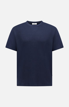 The NN07 Clive Waffle T-Shirt is a short-sleeve, crew neck navy blue top with a waffle-knit design—an essential addition to any modern-casual wardrobe, shown here against a white background.