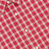 A close-up of the Deon Flannel Long Sleeve Shirt by NN07, showcasing its red and white plaid pattern in organic cotton flannel, detailed with white buttons and a visible NN07 label inside the collar—an essential addition to the modern casual wardrobe.