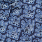 Close-up of the NN07 Deon Short Sleeve Print Shirt in navy blue with abstract light blue hand shapes, dark buttons, and a white NN07 tag on the top left. This modern-casual staple adds style to any wardrobe.