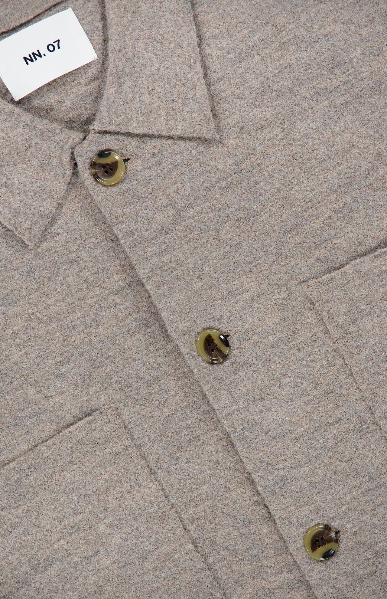 Close-up of the NN07 Jonas Polo Button Down Long Sleeve Sweater in beige-gray wool, ideal for a modern-casual wardrobe. Features include olive green buttons, two chest pockets, and a white NN07 brand label visible at the top left.