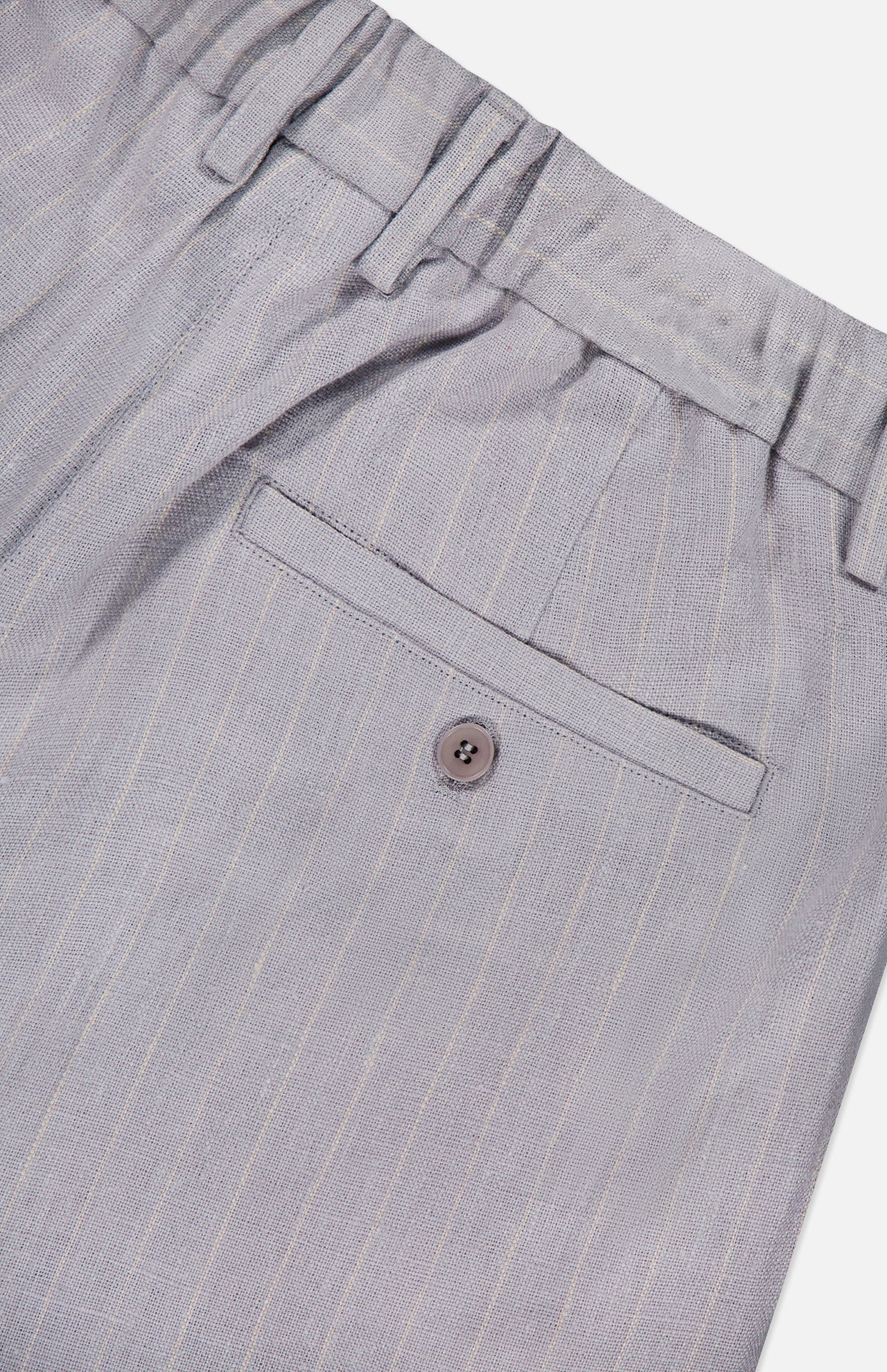 Close-up of the back pocket on the NN07 Kay Striped Linen Trouser Pant in light gray, showing a single button closure, belt loops at the waist, and a relaxed straight-leg fit.