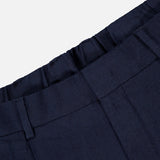 Close-up of the waistband and upper section of the NN07 Kay Relaxed-fit Trouser Pant in dark navy, highlighting belt loops, a front seam, and part of the waistband against a plain light background.