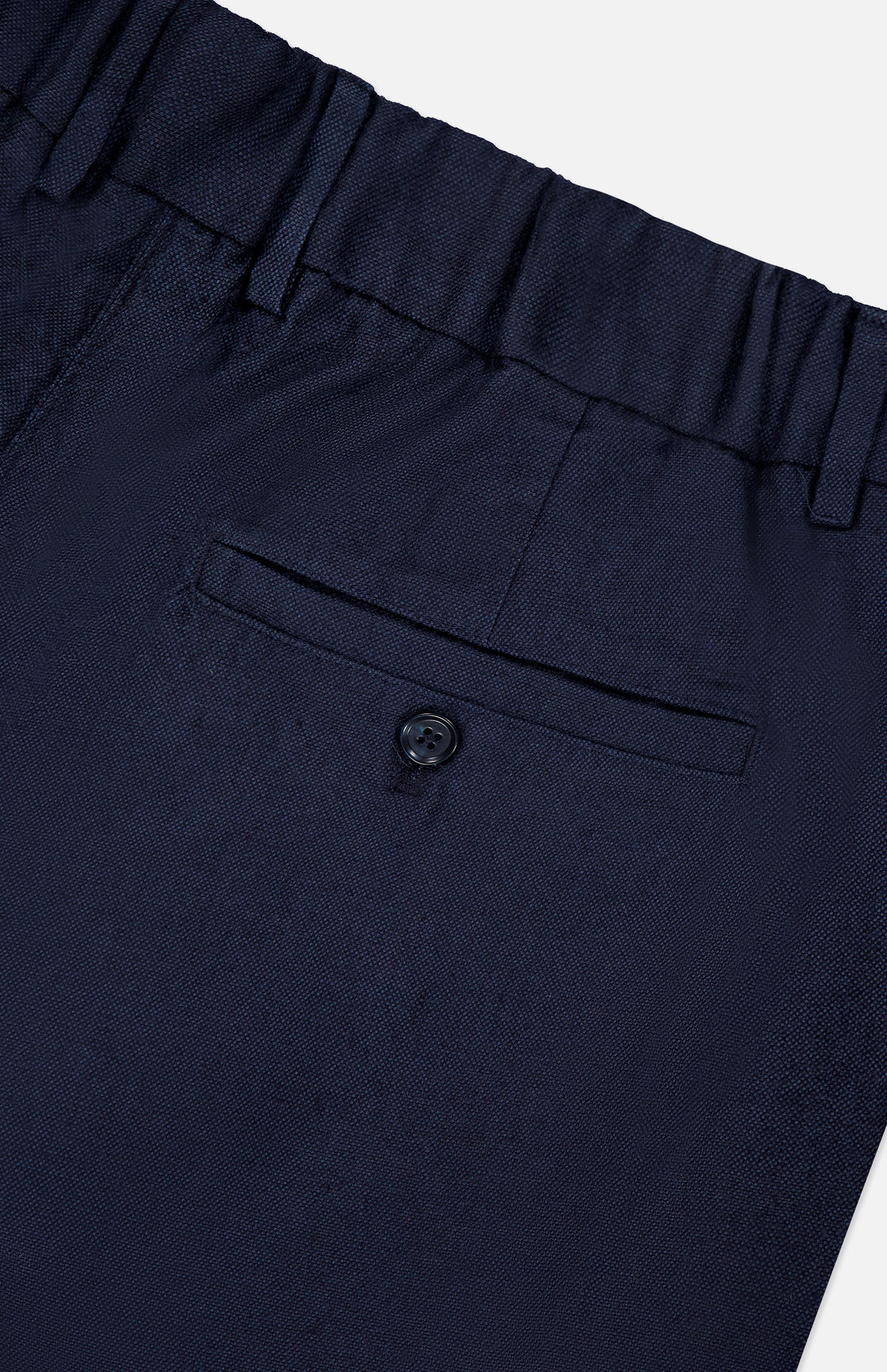 Close-up of NN07’s Kay Relaxed-fit Trouser Pant in navy, featuring an elastic waistband, a single buttoned welt back pocket, and subtly textured fabric for a modern look.