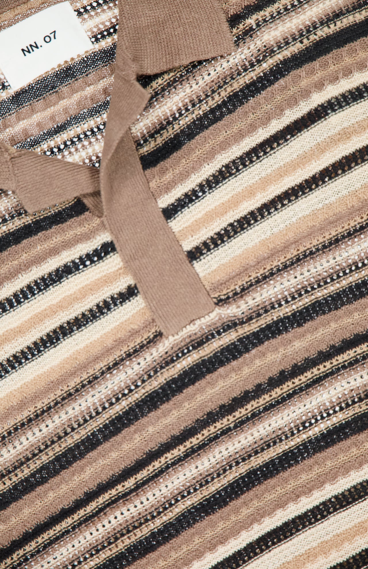 Close-up of the Noam Linen Knit Polo Shirt by NN07, featuring brown, beige, black, and white stripes with a casual Jonny collar. The NN07 tag near the collar emphasizes the shirt's varied textures and knit's thickness.
