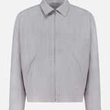 The NN07 Petrus Striped Linen Jacket is a light grey, long-sleeve European linen jacket with vertical pinstripes, front zipper, two angled pockets, classic collar, and straight cuffs, shown on a plain white background.