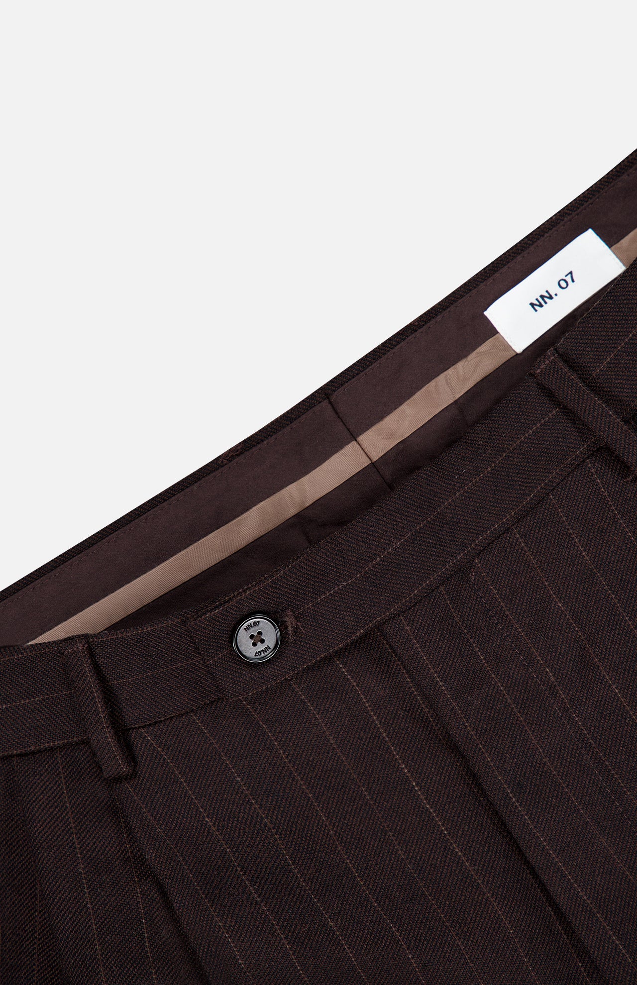 Close-up of the waistband and button closure of the brown pinstripe Robin Pinstripe Trouser Pant.