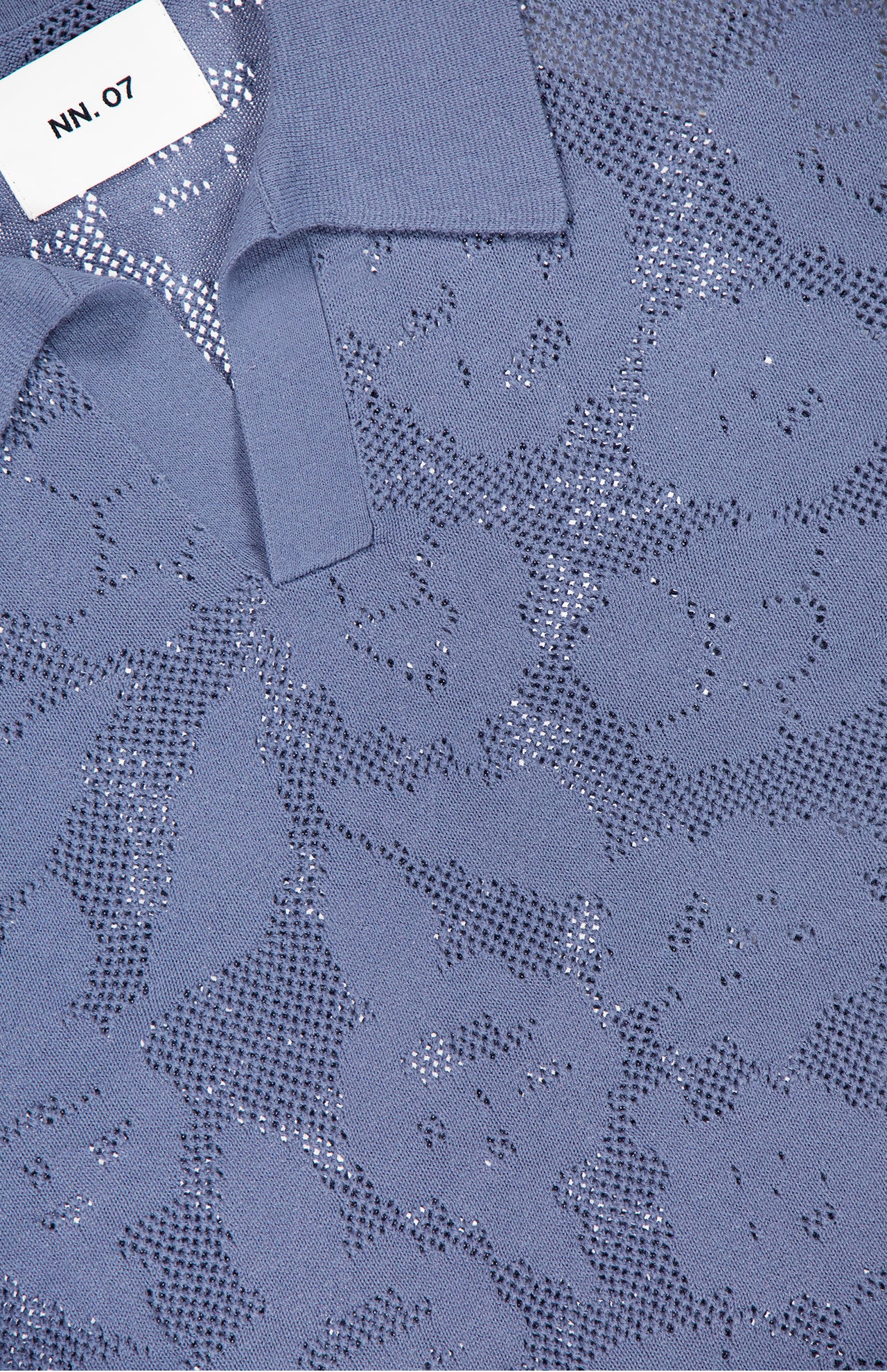 Close-up of the NN07 Ryan Flower Design Short Sleeve Shirt featuring a subtle, textured mesh pattern and a white NN07 label near the collar.