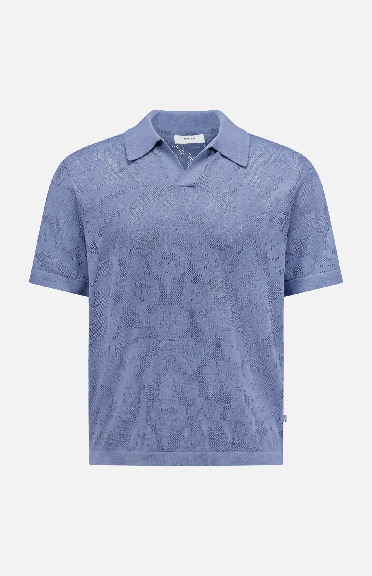 The Ryan Flower Design Short Sleeve Shirt by NN07 is a light blue organic cotton polo, featuring a subtle flower jacquard pattern, collar, and straight hem, shown on a plain white background.