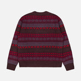 The Tobias V-Neck Sweater by NN07 showcases a bold berry palette with maroon, dark purple, and red geometric patterns in classic Fair Isle style. Featuring a flattering v-neckline and long sleeves, this knitted piece brings modern versatility to any casual wardrobe.