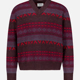 Introducing the Tobias V-Neck Sweater by NN07—a striking berry colorway sweater featuring red, maroon, and purple geometric Fair Isle patterns. This modern-casual piece boasts a maroon and purple V-neck design with long sleeves, making it an eye-catching addition to your wardrobe. Shown against a plain white background.