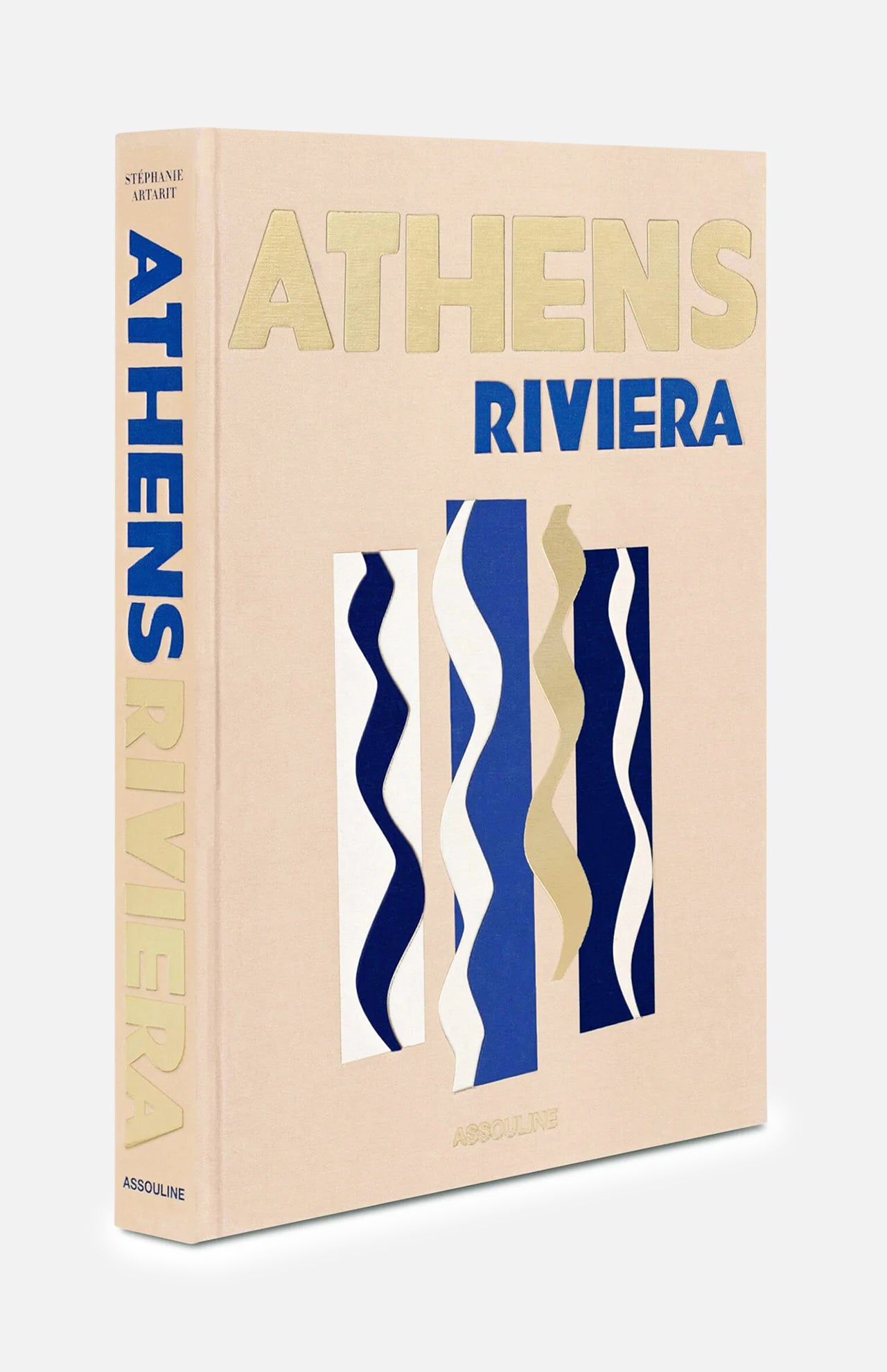 A beige hardcover book by ASSOULINE titled “Athens Riviera,” featuring gold and blue text with abstract wavy blue and white designs on the cover and spine, celebrates the captivating Athens Riviera and Greece’s renowned luxury hotels like the iconic Four Seasons Astir Palace.